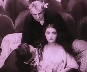 Screenshot from "The Cabinet of Dr. Caligari." Jane looks stern as she declares that Cesare abducted her.